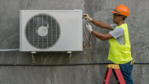 HVAC technician is checking outdoor air conditioner unit